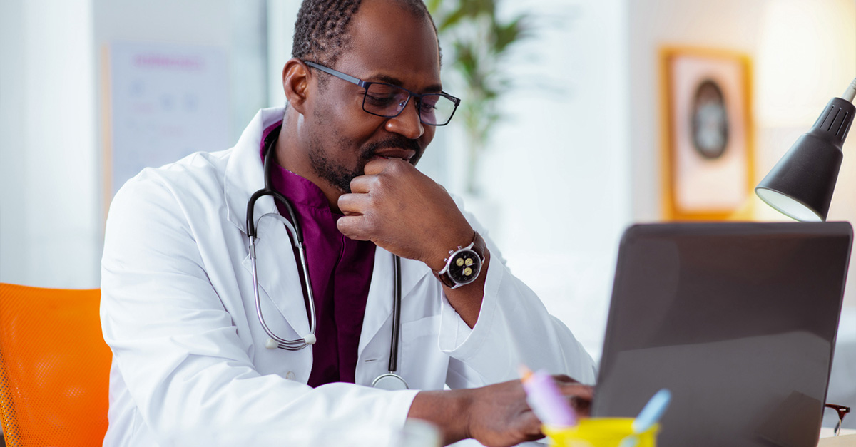African American doctor on his work laptop.